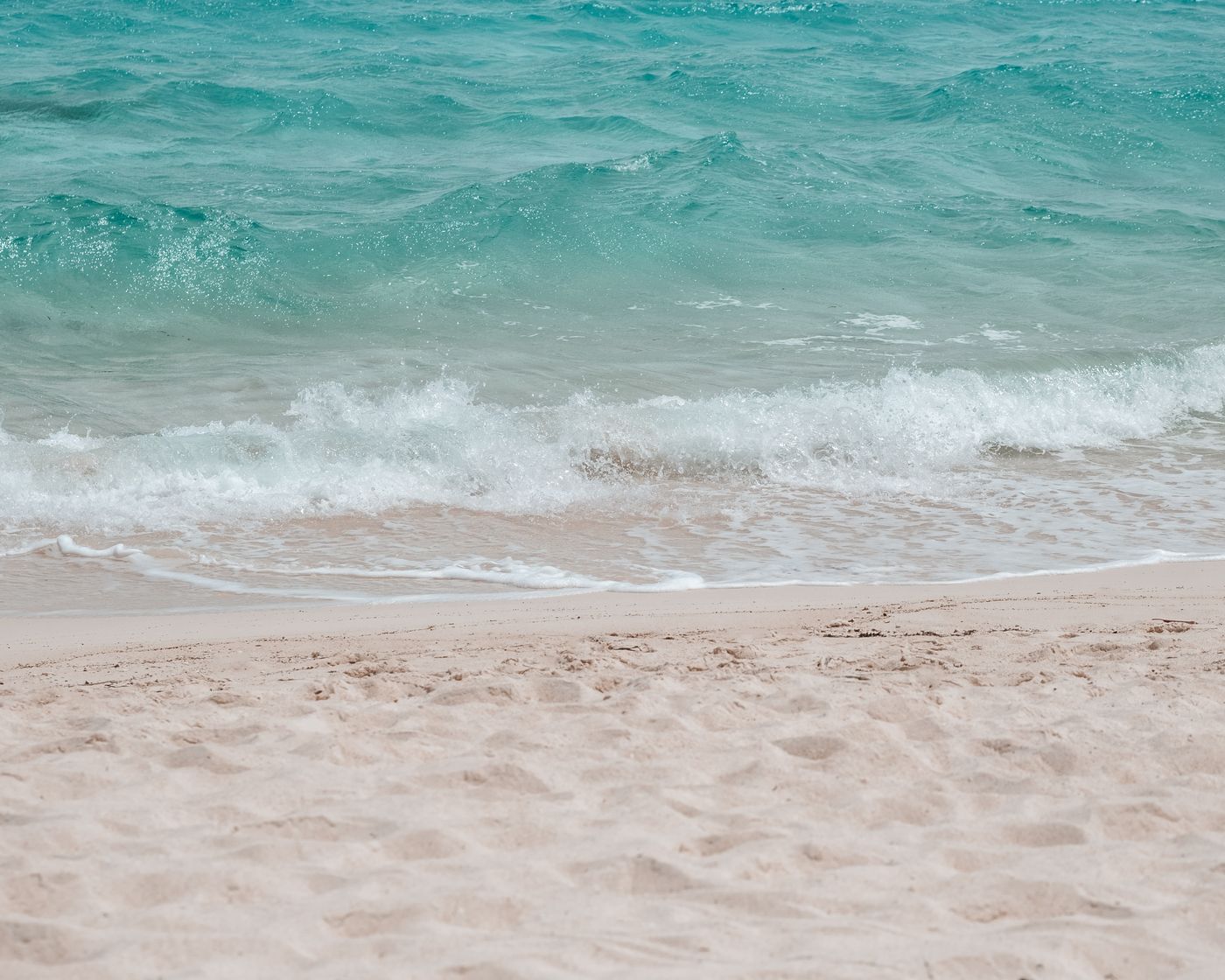 Open sand and surf on a summer afternoon