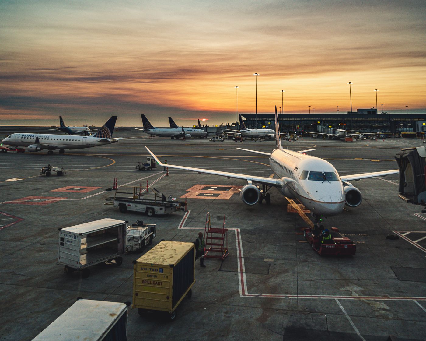 Aircraft at terminal gates at sunset